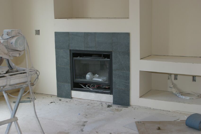 Green slate surrounds the gas fireplace