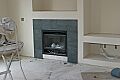 Green slate surrounds the gas fireplace