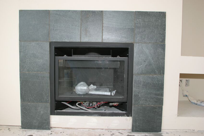 Green slate surrounds the gas fireplace