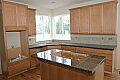 Granite tile on the island cooktop and surrounding counters
