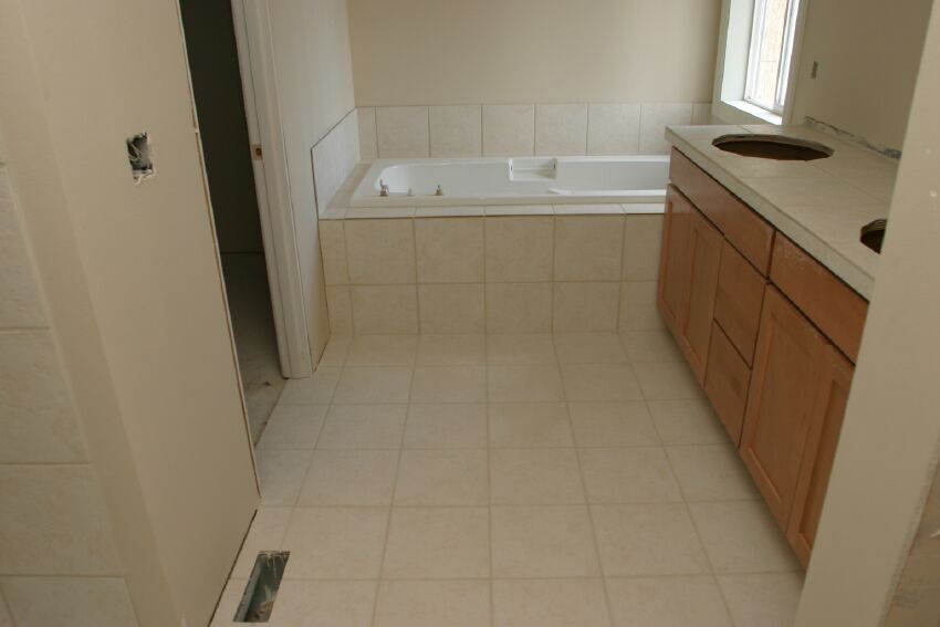 Slate tile is used throughout the master bath