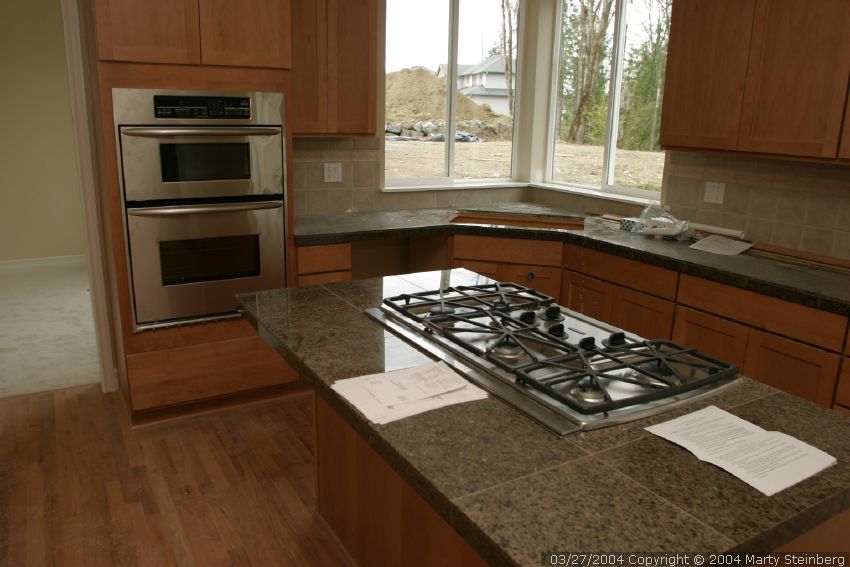 Stove and cooktop are in. Check out the hardwood floors too.